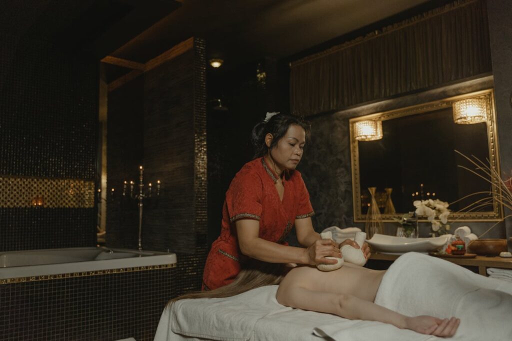 A Masseuse Massaging a Woman